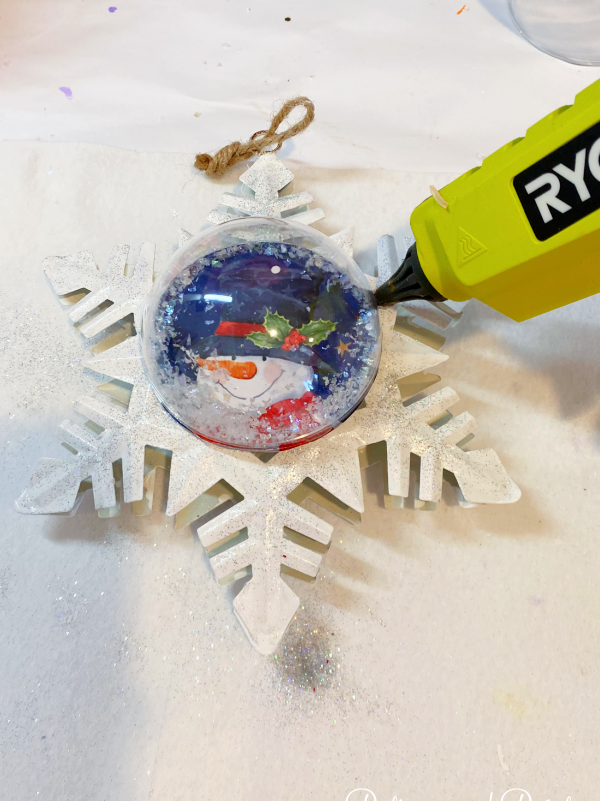 gluing an ornament to a snowflake