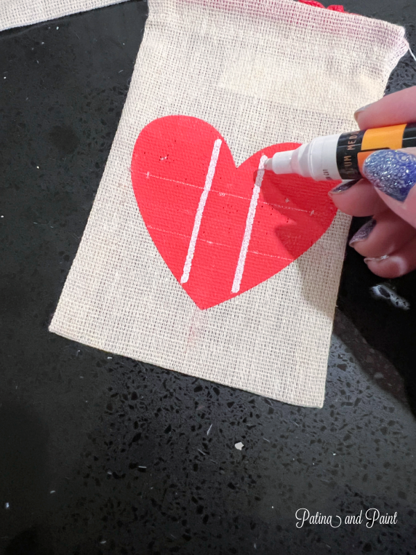 painting on a Valentine heart bag